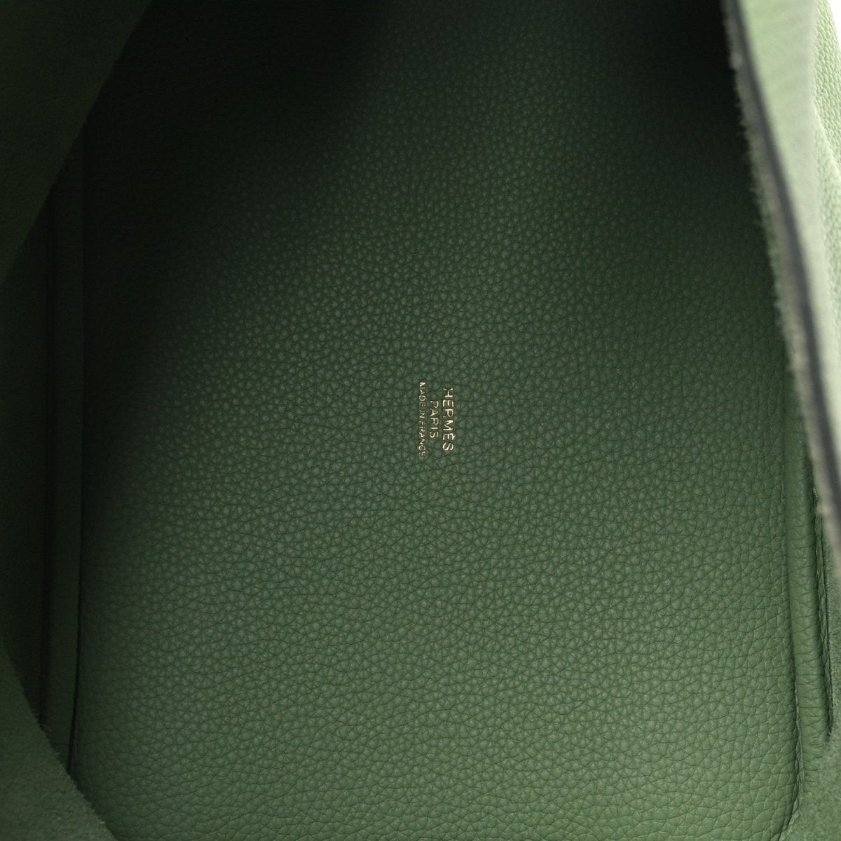 Green leather interior panel with embossed logo text