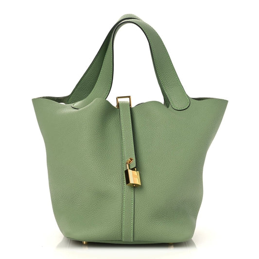 Green leather bucket bag with top handles and gold-tone lock detail on front