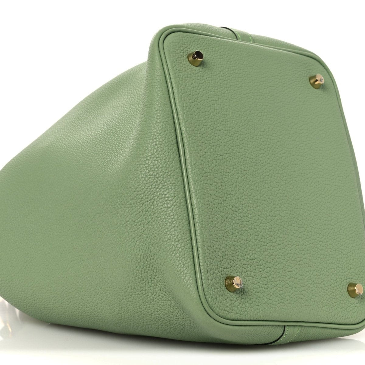 Green leather bucket bag top corner with gold-tone studs and curved pocket seam