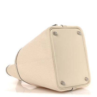 Cream canvas tote bag with back panel, metal corner studs, and side opening