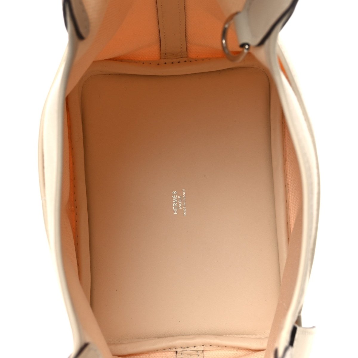 Cream leather-lined tote interior with stitched seams and brand stamp