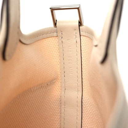 Cream canvas tote handle with metal D-ring and stitched reinforcement