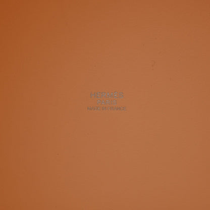 Orange leather interior panel with centered embossed logo