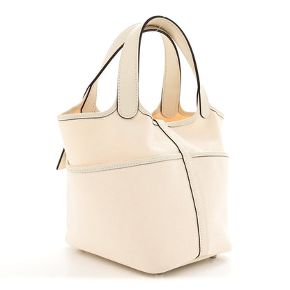 Nata canvas tote bag with top handles, front pocket, and structured side profile